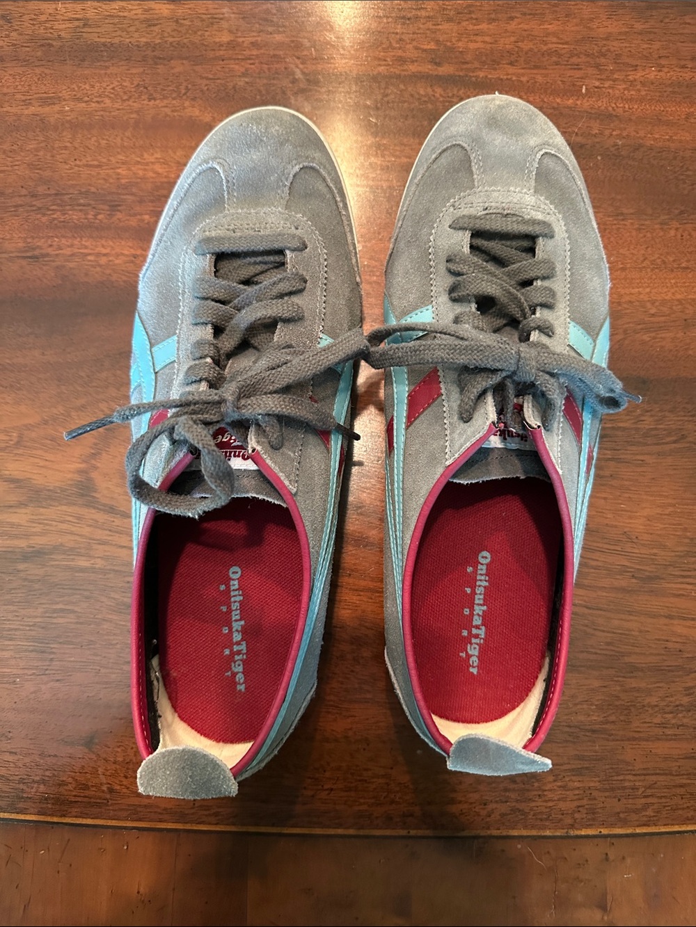 Onitsuka Tiger Men’s Gray Suede Sneakers with Light Blue and Red stripes.